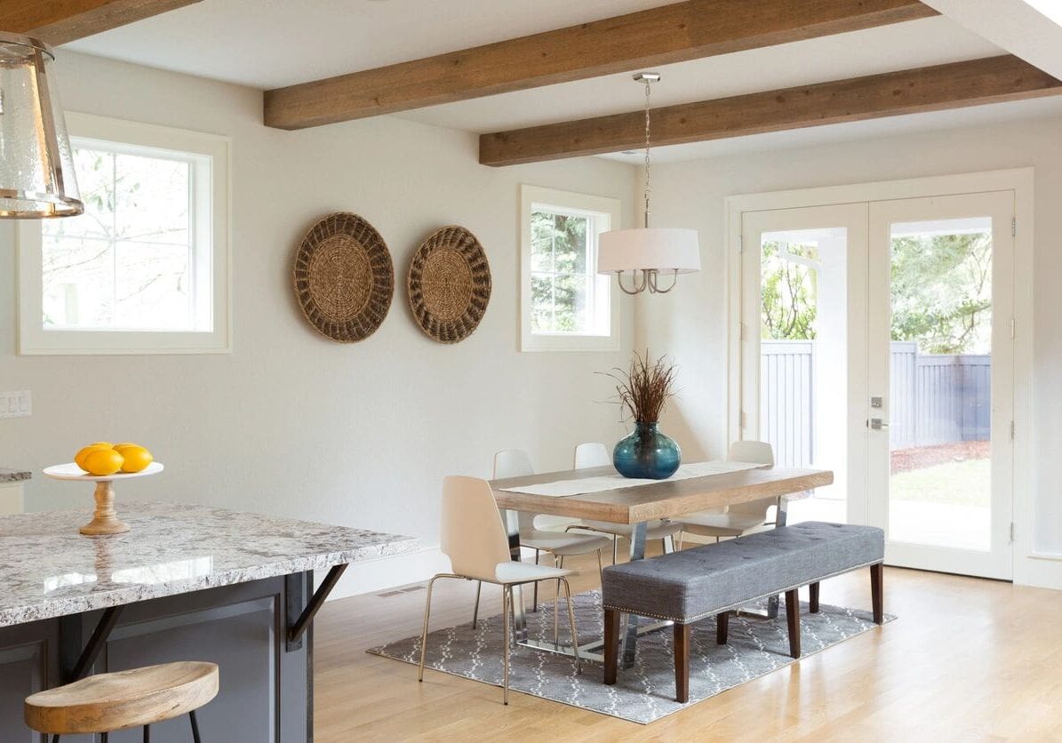 A dining room with two baskets on the wall.